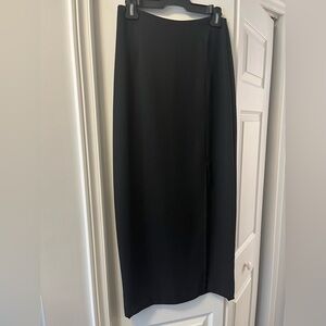 Mid calf length black pencil skirt. Front side slit.